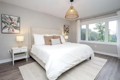 a white bedroom with a large bed and a window at Peak Perfection at The Blue Mountains in Blue Mountains