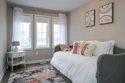 a bedroom with a bed and two windows at Peak Perfection at The Blue Mountains in Blue Mountains