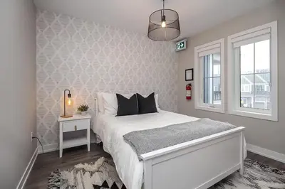a white bedroom with a bed and a window at Peak Perfection at The Blue Mountains in Blue Mountains