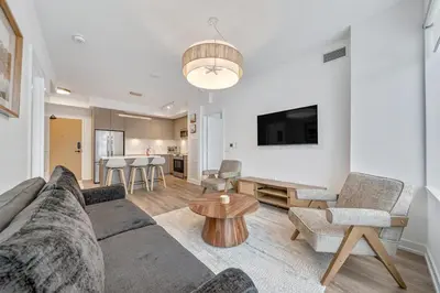 a living room with a couch and a table at Your Friday Harbour Escape Awaits! in Innisfil