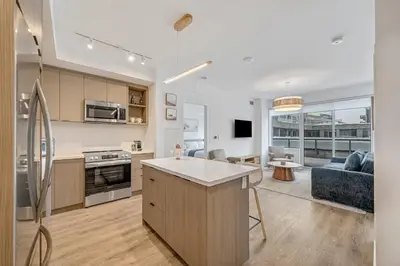 an open kitchen and living room with a couch at Your Friday Harbour Escape Awaits! in Innisfil