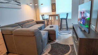 a living room with a couch and a flat screen tv at 17 Zorra street in Toronto