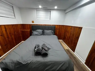 a bed with two pairs of shoes on it at Prime Location 3Bedrooms, 2 Bath, Basement Apartment with parking- Streetsville Area, Close to Transit- Sleeps 6 in Mississauga