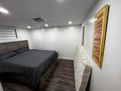 a bedroom with a bed and a chair in it at Prime Location 3Bedrooms, 2 Bath, Basement Apartment with parking- Streetsville Area, Close to Transit- Sleeps 6 in Mississauga