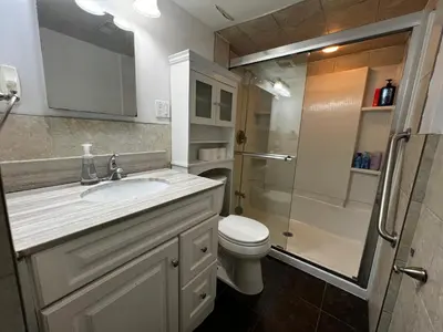 a bathroom with a toilet and a sink and a shower at Prime Location 3Bedrooms, 2 Bath, Basement Apartment with parking- Streetsville Area, Close to Transit- Sleeps 6 in Mississauga