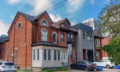 a brick house with cars parked in front of it at Home Base Executive Rental in Hamilton in Hamilton