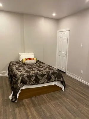 a bedroom with a bed with a pillow on it at Home Base Executive Rental in Hamilton in Hamilton