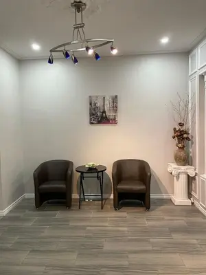 a waiting room with two chairs and a table at Home Base Executive Rental in Hamilton in Hamilton