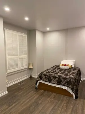 a bedroom with a bed and a window at Home Base Executive Rental in Hamilton in Hamilton