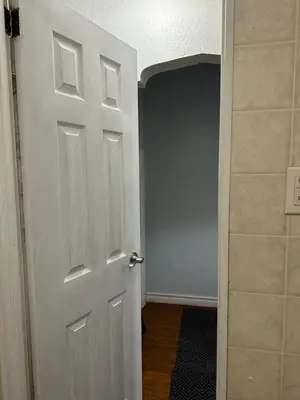 an empty room with a white door and a hallway at Space Share Accommodation East York Budget Friendly in Toronto