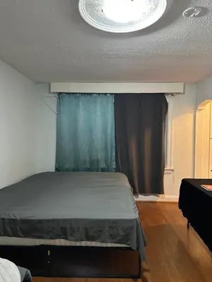 a bedroom with a bed in a room with a window at Space Share Accommodation East York Budget Friendly in Toronto