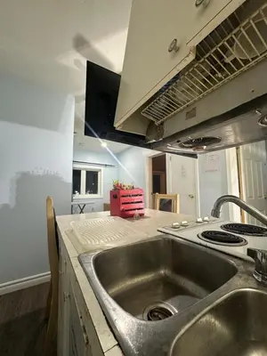 a kitchen with a sink and a stove at Space Share Accommodation East York Budget Friendly in Toronto
