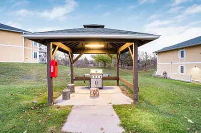 a gazebo with a bench in a yard at Luxury Jacuzzi Suite with Sauna & Heated Pool in Shanty Bay