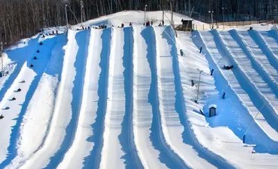 a ski slope covered in snow with people skiing at Luxury Jacuzzi Suite with Sauna & Heated Pool in Shanty Bay