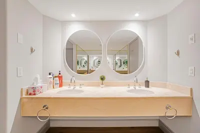 a bathroom with two sinks and a large mirror at Luxury Jacuzzi Suite with Sauna & Heated Pool in Shanty Bay