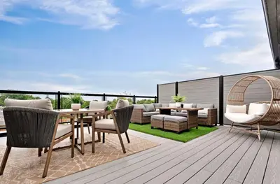 a patio with a table and chairs on a deck at 2Bdrm Penthouse Close To Falls With Parking in Niagara Falls