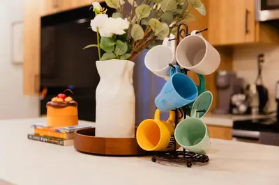 a group of cups sitting on a counter with a vase at Central Getaway University of Toronto TTC Queen M in Toronto
