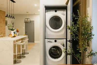 a laundry room with two washer and dryer at Central Getaway University of Toronto TTC Queen M in Toronto