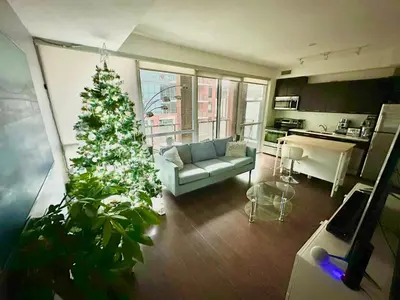 a living room with a christmas tree and a couch at Luxury smart condo downtown Toronto in Toronto