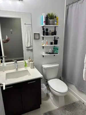 a bathroom with a toilet and a sink and a mirror at Luxury smart condo downtown Toronto in Toronto