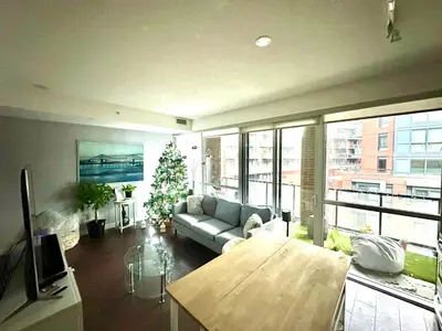 a living room with a couch and a christmas tree at Luxury smart condo downtown Toronto in Toronto