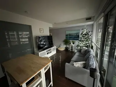 a living room with a christmas tree and a couch at Luxury smart condo downtown Toronto in Toronto