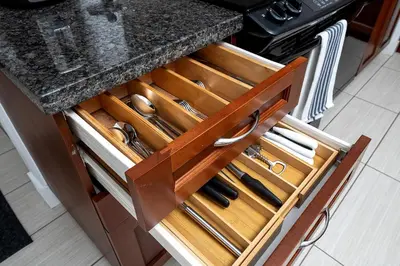 a kitchen counter with wooden drawers with knives at Comfort and Beauty in the heart of Tor | W Parking in Toronto
