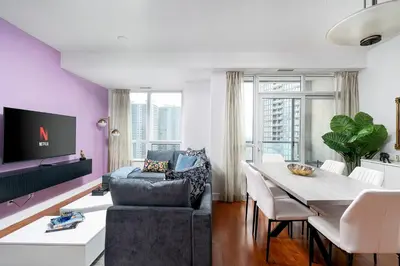 a living room with a table and a couch at Comfort and Beauty in the heart of Tor | W Parking in Toronto