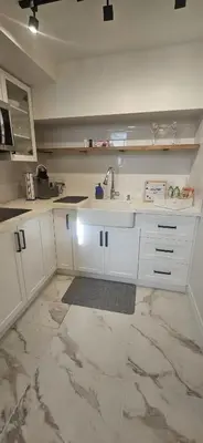a kitchen with white cabinets and a sink at Apartment Near Downtown Toronto & The Beaches in Toronto