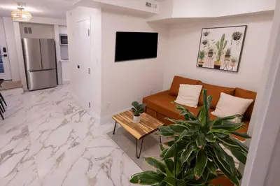 a living room with a couch and a table at Apartment Near Downtown Toronto & The Beaches in Toronto
