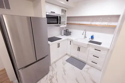 a kitchen with a refrigerator and a sink at Apartment Near Downtown Toronto & The Beaches in Toronto