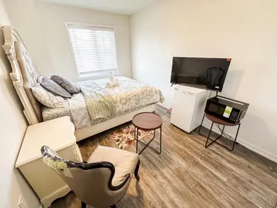 a small bedroom with a bed and a television at Quiet Haven in Oshawa