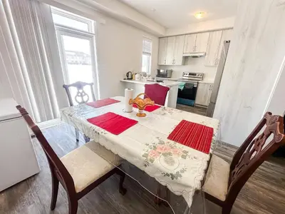 a kitchen with a table with a table cloth on it at Quiet Haven in Oshawa