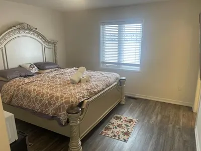 a bedroom with a bed with two candles on it at Quiet Haven in Oshawa