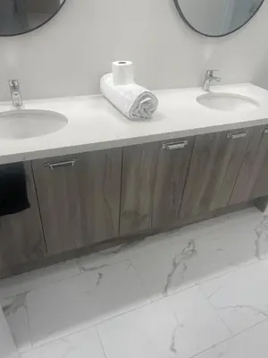 a bathroom with two sinks and a mirror at Quiet Haven in Oshawa