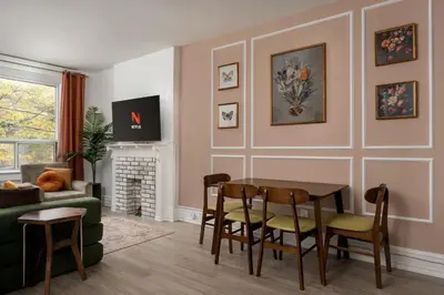 a living room with a table and chairs at Vintage Charm on Roncesvalles in Toronto