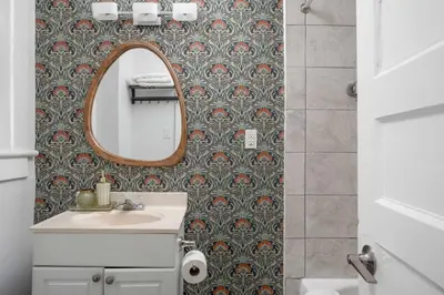 a bathroom with a sink and a mirror at Vintage Charm on Roncesvalles in Toronto