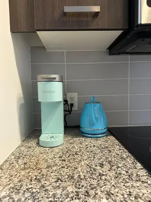 a appliance sitting on a counter in a kitchen at Brightly Lit Suite Centrally Located |UofT|Ryerson in Toronto