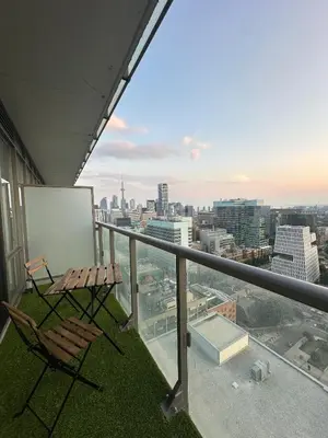 a balcony with a table and chairs on a building at Brightly Lit Suite Centrally Located |UofT|Ryerson in Toronto