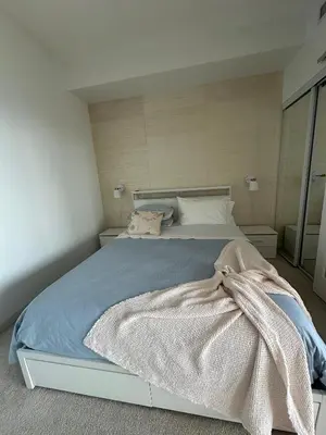 a bedroom with a bed with a blanket on it at Brightly Lit Suite Centrally Located |UofT|Ryerson in Toronto