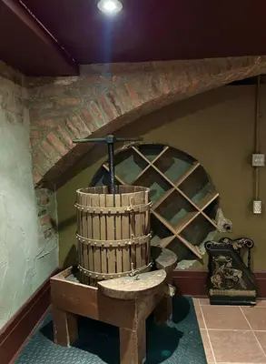a wooden barrel in a room with a brick wall at The Farmhouse Manor B&B in St. Catharines
