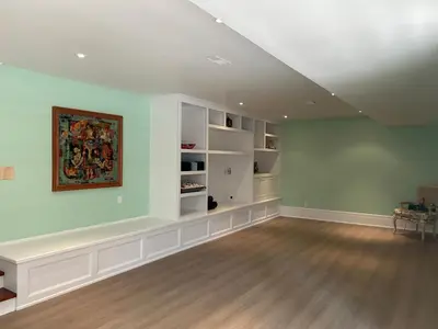 an empty living room with a painting on the wall at The Farmhouse Manor B&B in St. Catharines