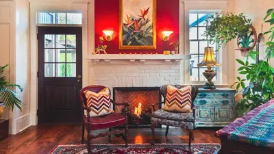 a living room with two chairs and a fireplace at The Farmhouse Manor B&B in St. Catharines