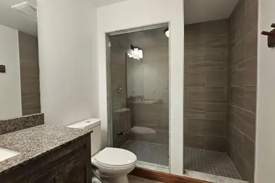 a bathroom with a toilet and a walk in shower at Grand 8-Bedroom Retreat 7 Baths Hot Tubs - Perfect Chalet in Blue Mountains