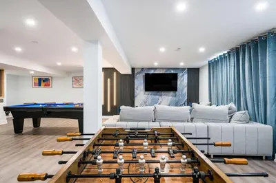 a living room with a pool table and a couch at Large Chalet Hideaway - Hottub-SwimSpa - Sauna in Blue Mountains