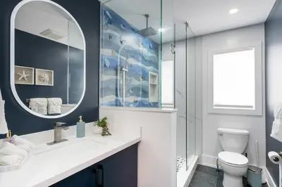 a bathroom with a white toilet and a mirror at Large Chalet Hideaway - Hottub-SwimSpa - Sauna in Blue Mountains