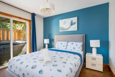 a bedroom with a bed with a blue wall at Large Chalet Hideaway - Hottub-SwimSpa - Sauna in Blue Mountains
