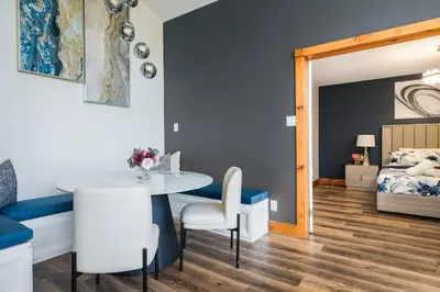 a room with a table and chairs and a bed at Large Chalet Hideaway - Hottub-SwimSpa - Sauna in Blue Mountains