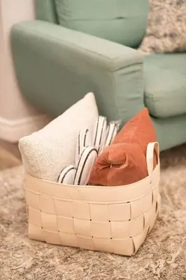 a basket filled with towels and a couch at Luma Lakehouse Icewine Lakefront | Deck + Hot Tub in St. Catharines