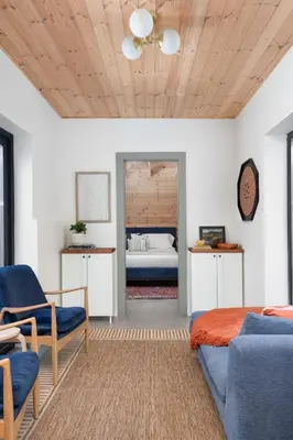 a living room with a bed and a couch and chairs at Sauna Hot Tub Lake Off-Grid AFrame Retreat in Gravenhurst